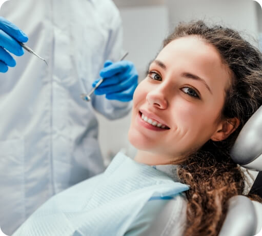 Woman smiling during dental checkup and teeth cleaning visit