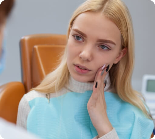 Woman discussing the cost of dental emergencies with her emergency dentist