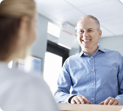 Dental patient and dentistry team member discussing the costs of dental implants