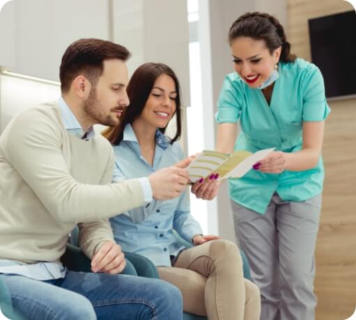 Dental team member discussing dental insurance coverage with dentistry patients