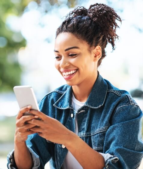 Woman exploring dental insurance providers on her phone