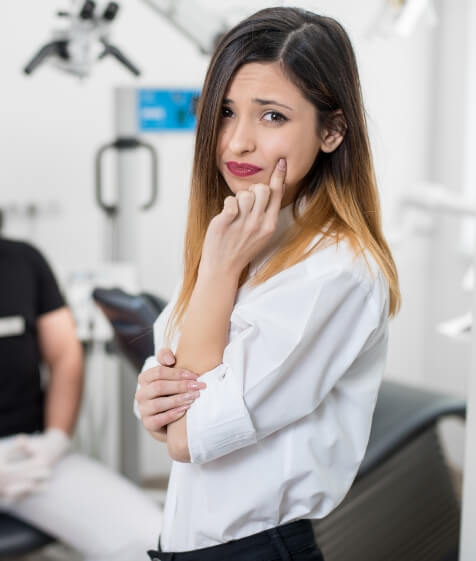 Woman with toothache before root canal treatment