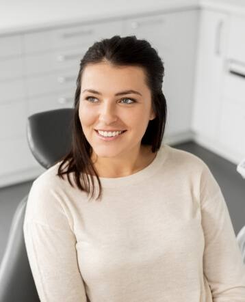 Woman in dental chair smiling during preventive dentistry visit