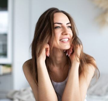 Woman with healthy smile after gum disease treatment