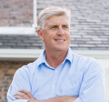 Man smiling replacing missing teeth